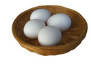 Four chicken eggs in a basket