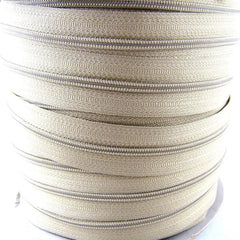 Roll of beige number 5 continuous zip chain on a roll. Front picture