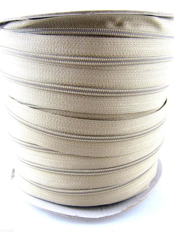 Roll of beige number 5 continuous zip chain on a roll. Front picture