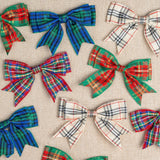 Plaid bows in various colors on a textured beige background