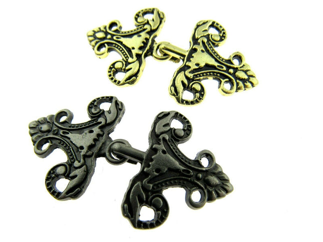 Oriental hook fastener in antique gold and silver on a white background