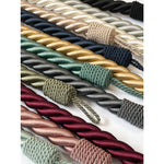 Collection of braided curtain tieback ropes in various colors on a white background