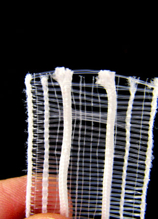 A close-up of transparent Austrian blind tape, showing its texture and weave.