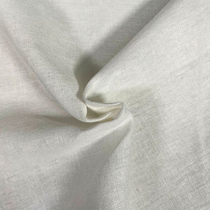 A close-up of draped off-white linen fabric with a visible woven texture and soft shadows in the folds.