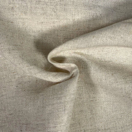 A close-up of draped light beige linen fabric with a visible woven texture and soft folds.