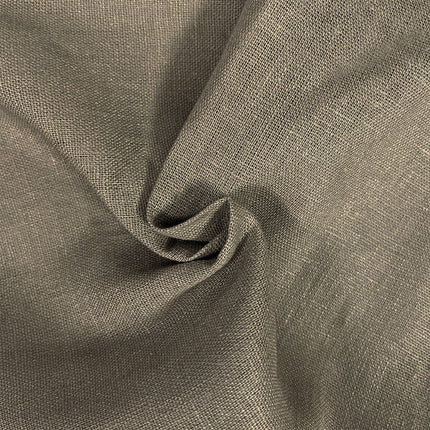 A close-up of draped fabric with a visible woven texture in a warm taupe-gray color, arranged in soft folds.