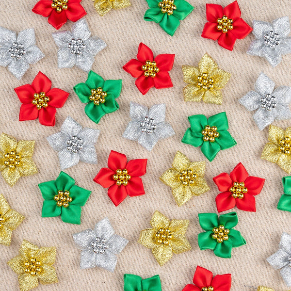 Colorful decorative Christmas poinsettia flowers on a beige background