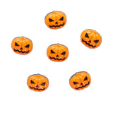 Set of six small orange pumpkin-shaped objects with jack-o'-lantern faces on a white background.