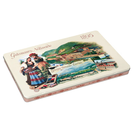 A rectangular metal tin of Göttingen’s Näbseide cookies, featuring a vintage-style scenic illustration of the Göttingen mountains and a traditional German woman on the front, with the text 'Göttingen’s Näbseide' and '1895'.