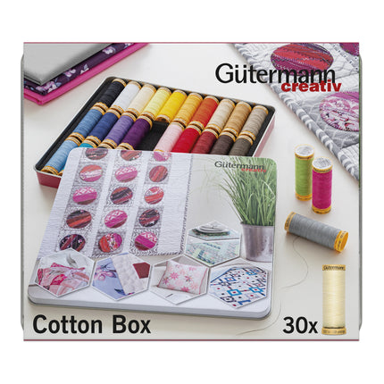 Gütermann Creativ Cotton Box thread set, featuring a 30-count variety pack of cotton sewing threads in a metal tin, shown alongside finished quilting samples and spools of thread on a white background.