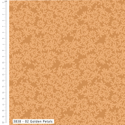 A fabric or wallpaper pattern swatch showing a repeating floral motif in light peach on a warm tan background, with a white measurement ruler along the left edge and a label reading '3838 - 02 Golden Petals' at the bottom.