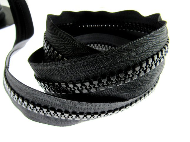 A close-up of a heavy-duty chunky plastic continuous zip chain, showing the teeth and the tape, on a white background.
