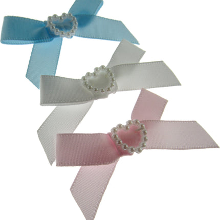 Three ribbon bows with decorative centers on a white background