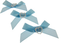 Three light blue hair bows with heart-shaped centers on a white background
