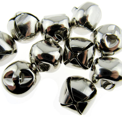 A pile of small shiny silver bells with a polished metallic finish, arranged on a plain white background.