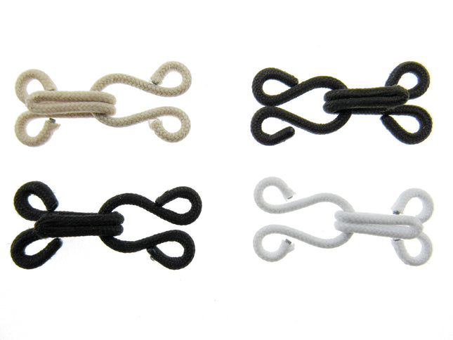 Set of four fur hooks and eyes in beige, black, and white on a white background