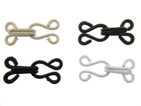 Set of four fur hooks and eyes in beige, black, and white on a white background