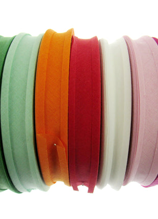 A collection of cotton bias binding bunting tape in various solid colors, including blue, green, orange, pink, white, and black, displayed side by side.