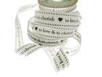 Spool of ribbon with text 'to love & to cherish' on a white background