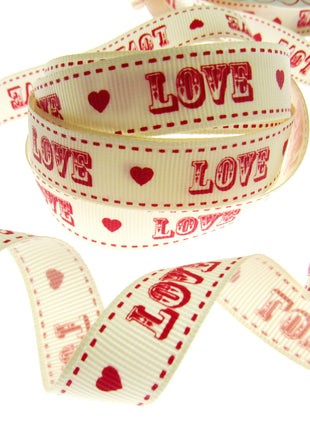 Ribbon with 'LOVE' and heart patterns on a white background