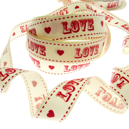 Ribbon with 'LOVE' and heart patterns on a white background