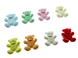 Assorted colorful teddy bear-shaped candies on a white background