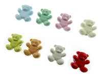 Colorful teddy bear-shaped candies on a white background
