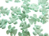 Green teddy bear-shaped candies on a white background