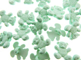 Green teddy bear-shaped candies on a white background