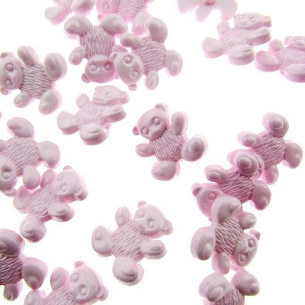 Pink teddy bear-shaped candies on a white background