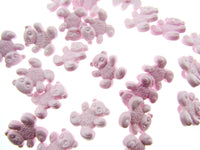 Pink teddy bear-shaped candies on a white background