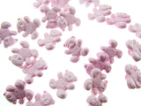 Pink teddy bear-shaped candies on a white background