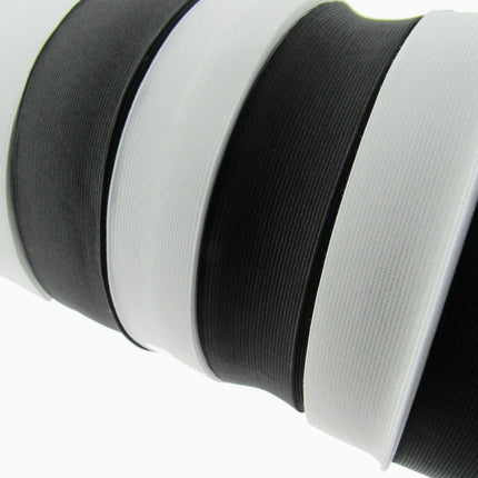 Close-up of black and white flat woven elastic on a white background