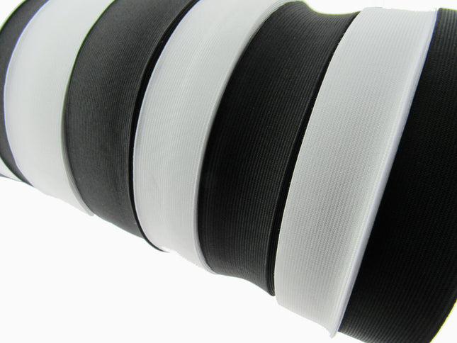 Close-up of black and white flat woven elastic on a white background