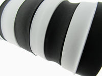 Close-up of black and white flat woven elastic on a white background