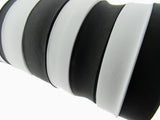 Close-up of black and white flat woven elastic on a white background