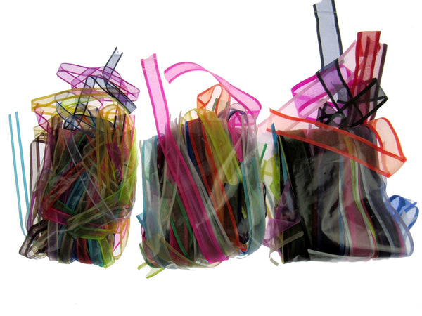 Colorful lengths of chiffon ribbon in clear bags on a white background