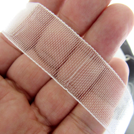 A close-up of a hand holding a strip of 19mm Bandex Roman Blind tape, 19mm wide without draw cords