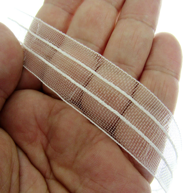 A close-up of a hand holding a strip of 19mm Bandex Roman Blind tape, 19mm wide with draw cords