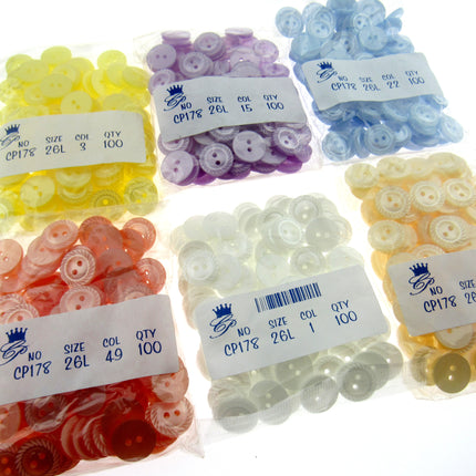 Assorted colorful buttons in clear bags with labels on a white background