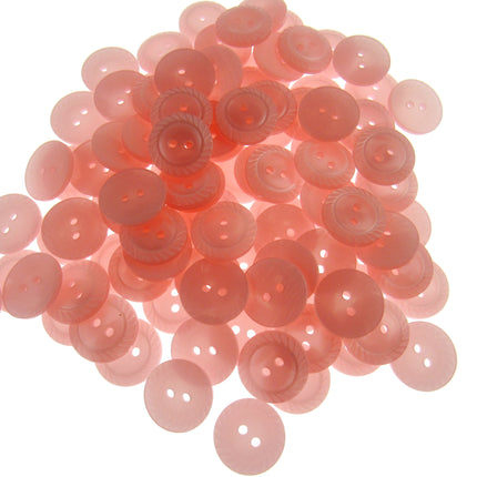 Pile of pink buttons on a white background