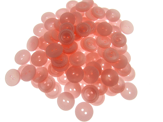 Pile of pink buttons on a white background
