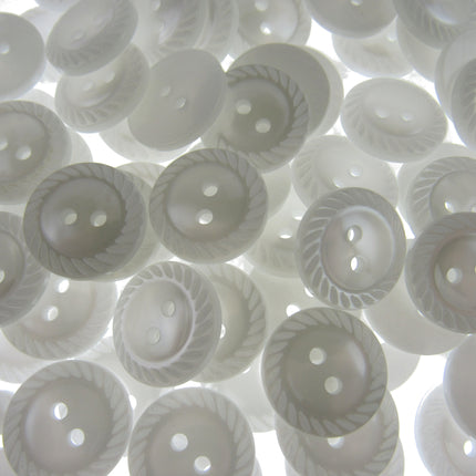 Close-up of white buttons with decorative patterns on a white background