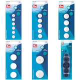 A selection of Pym plastic cover buttons arranged on a white background