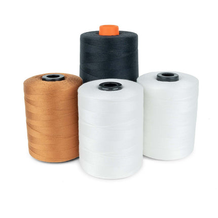 Four spools of sewing thread in black, white, natural, and ginger colors.
