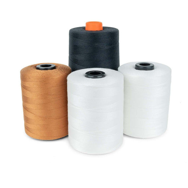 Four spools of sewing thread in black, white, natural, and ginger colors.