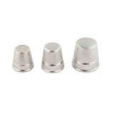 Closed end dressmaker thimbles on a white background