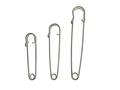 Three nickel plated steel kilt pins in different sizes, isolated on a white background.