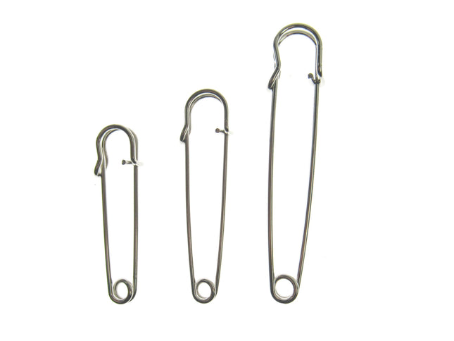 Three nickel plated steel kilt pins in different sizes, isolated on a white background.