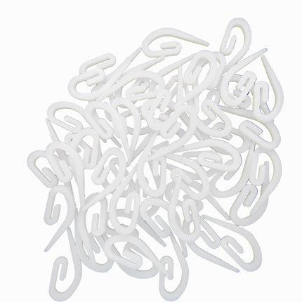 White plastic hooks on a white background